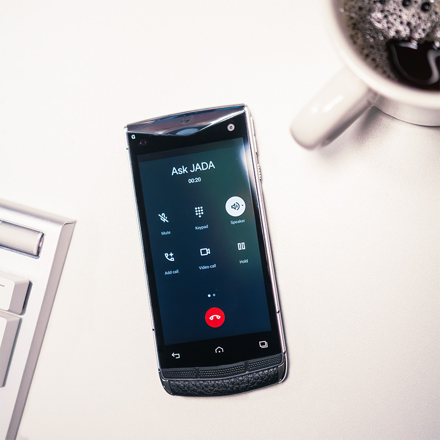 phone on table showing active call with JADA